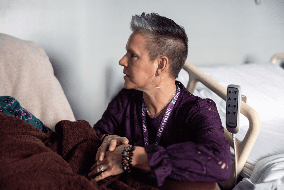 Nurse practitioner holding a patient's hand