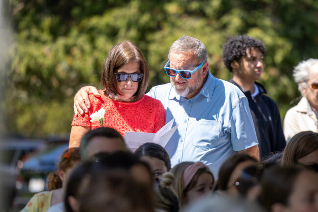 Couple embracing while reading an event program