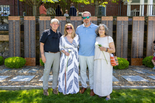 Family of four in front of Emilson Family Wall of Remembrance