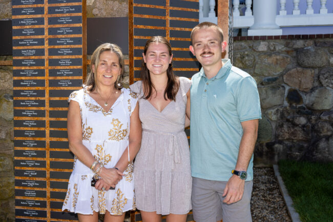 Family in front of Emilson Family Wall of Remembrance
