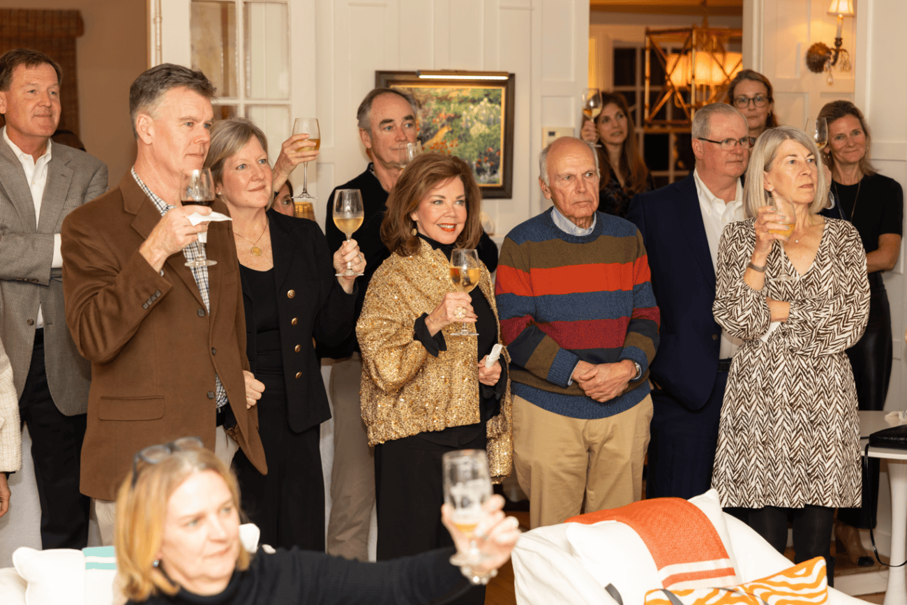 Group of people raising their glasses