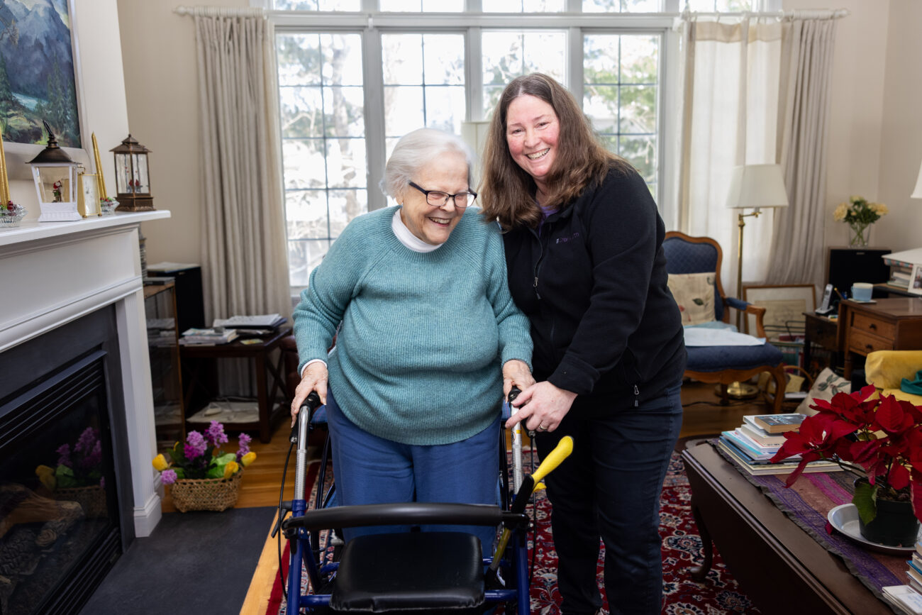 Physical therapy assistant walking with patient