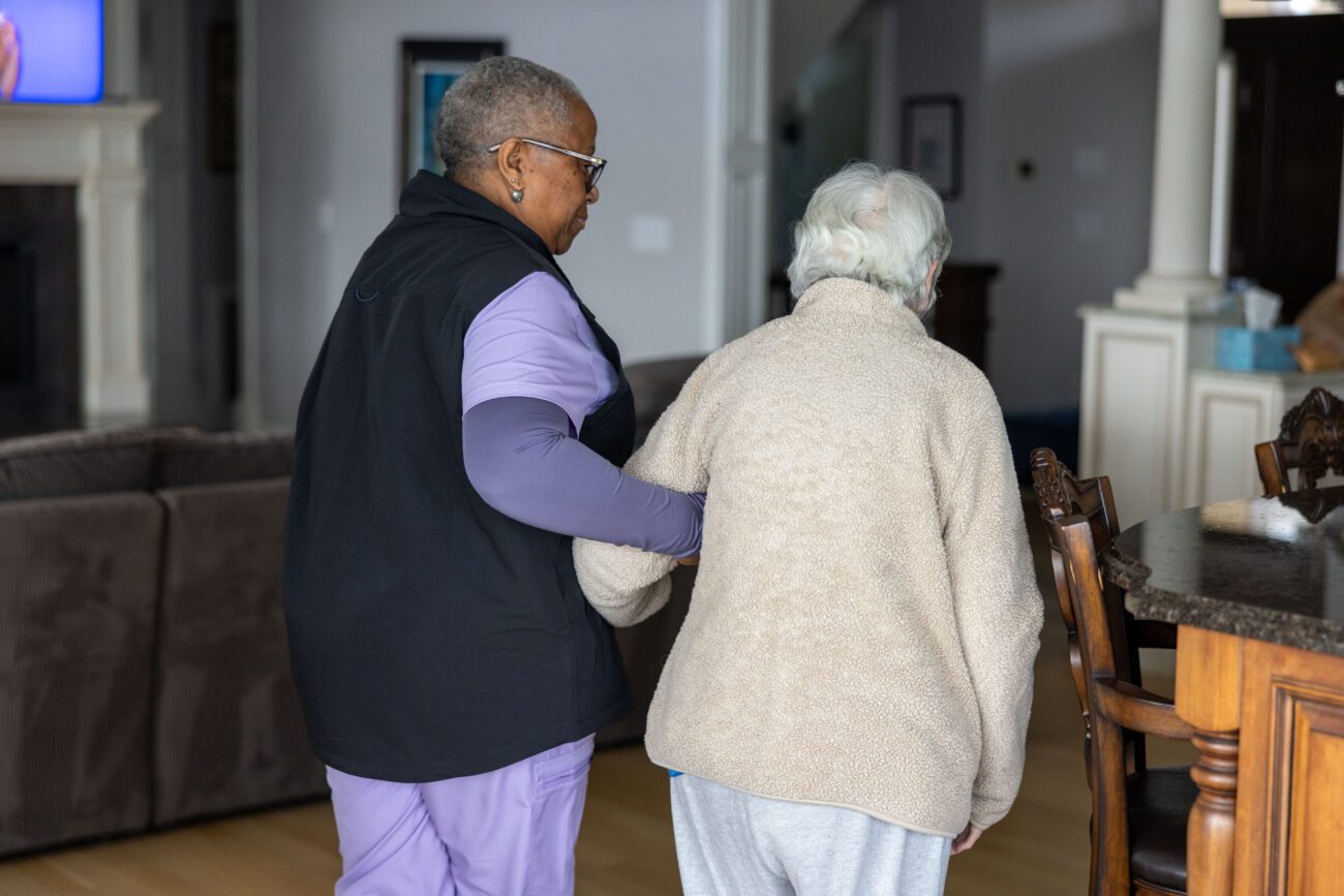 Home care nurse walking with patient